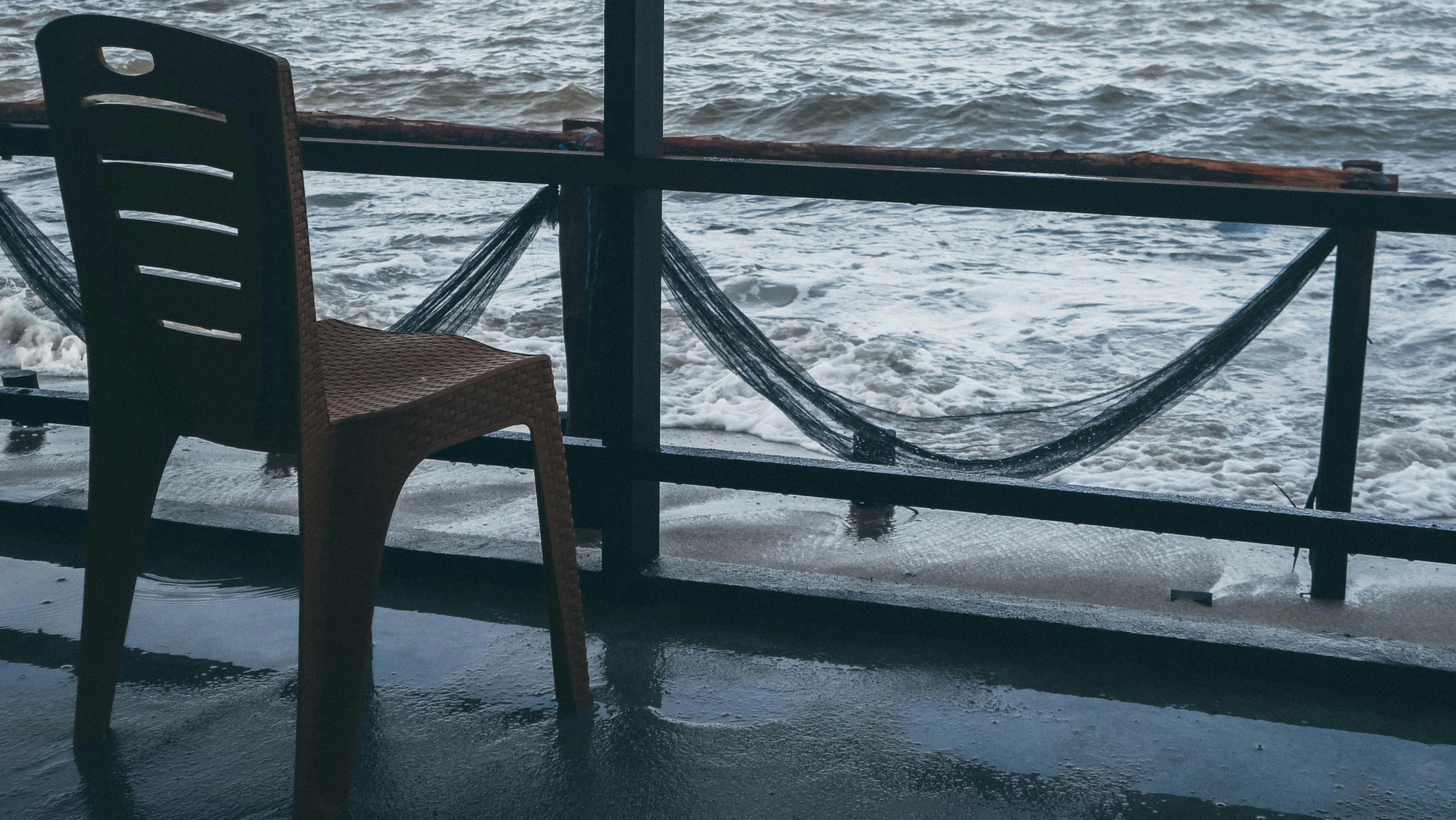 A chair faces the ocean waves.