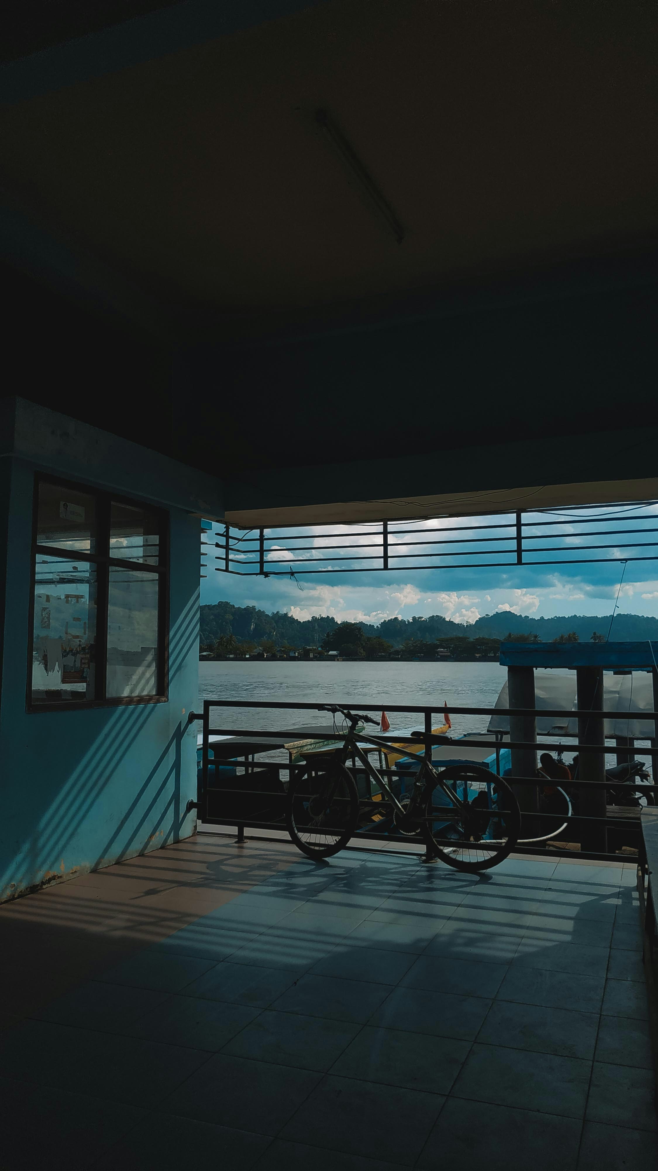A bicycle is parked by the lake view.