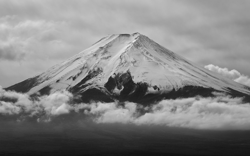 a black and white photo of a snow covered mountain