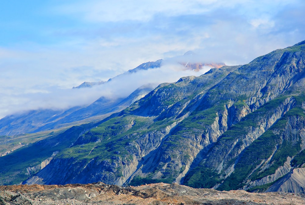 a view of a mountain range with clouds in the sky