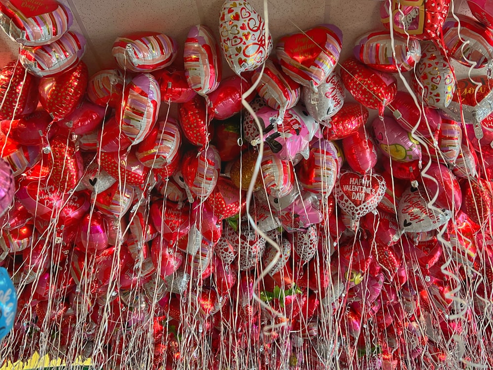 a bunch of red and white shoes hanging on a wall