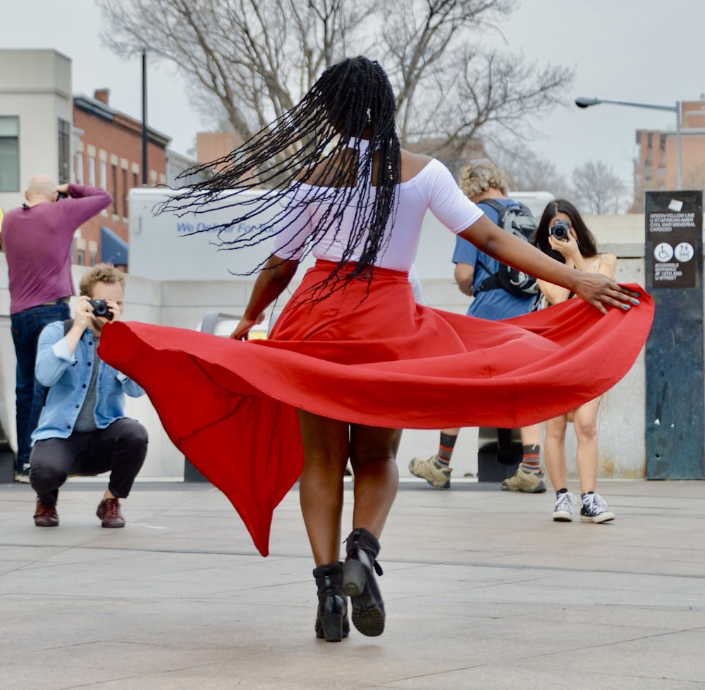 uma mulher em um vestido vermelho está dançando