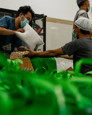 a group of people in a room with masks on