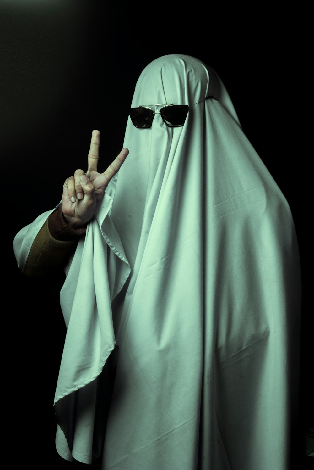 a person in a nun costume making a peace sign