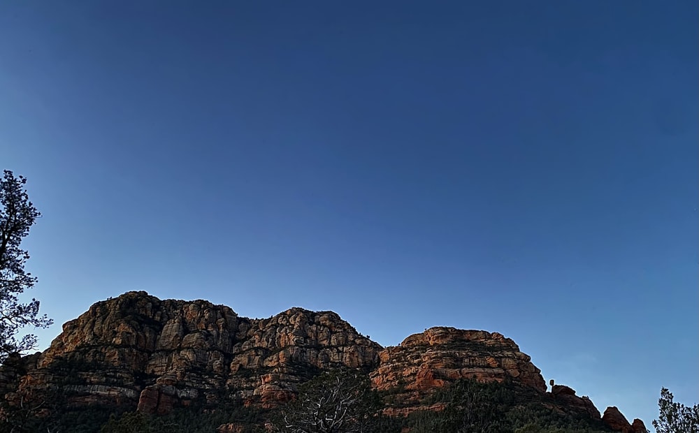 a group of mountains with a blue sky in the background