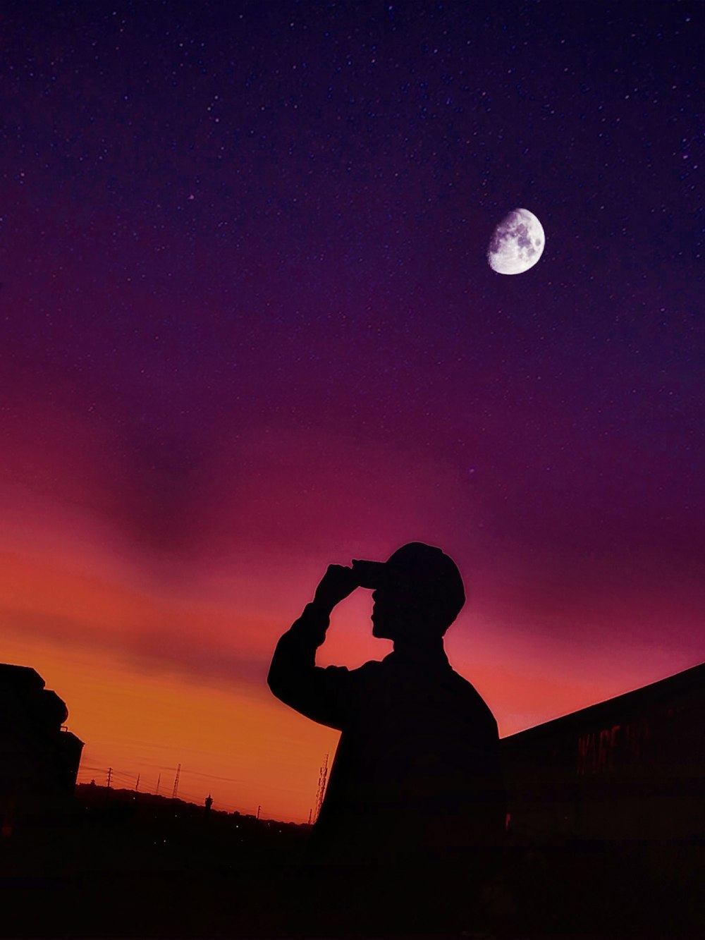 a man standing in front of a purple sky