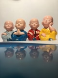 a group of buddha statues sitting on top of a table