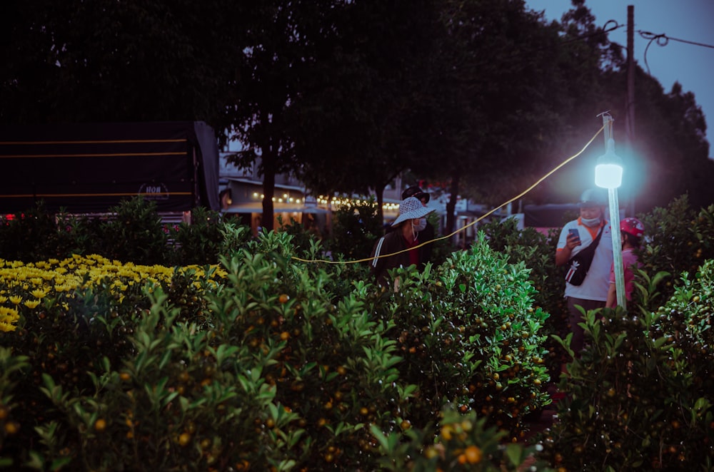 a couple of people that are standing in the grass