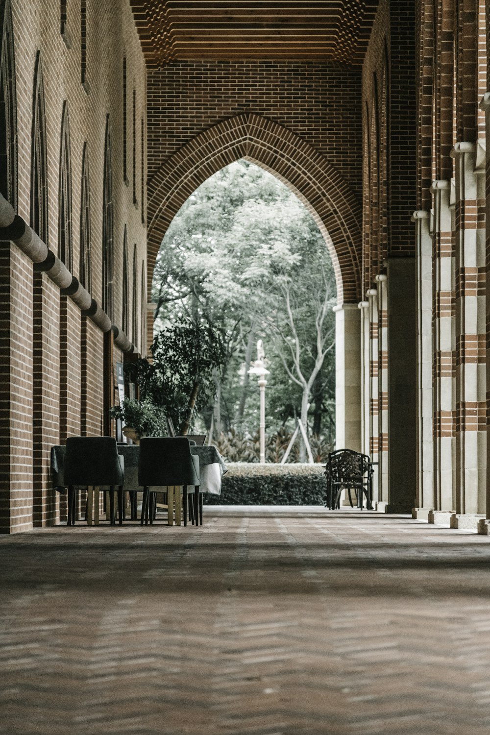 a room with a large brick wall and a piano on the floor