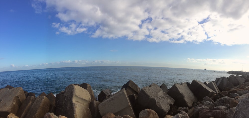 a view of the ocean from a rocky shore