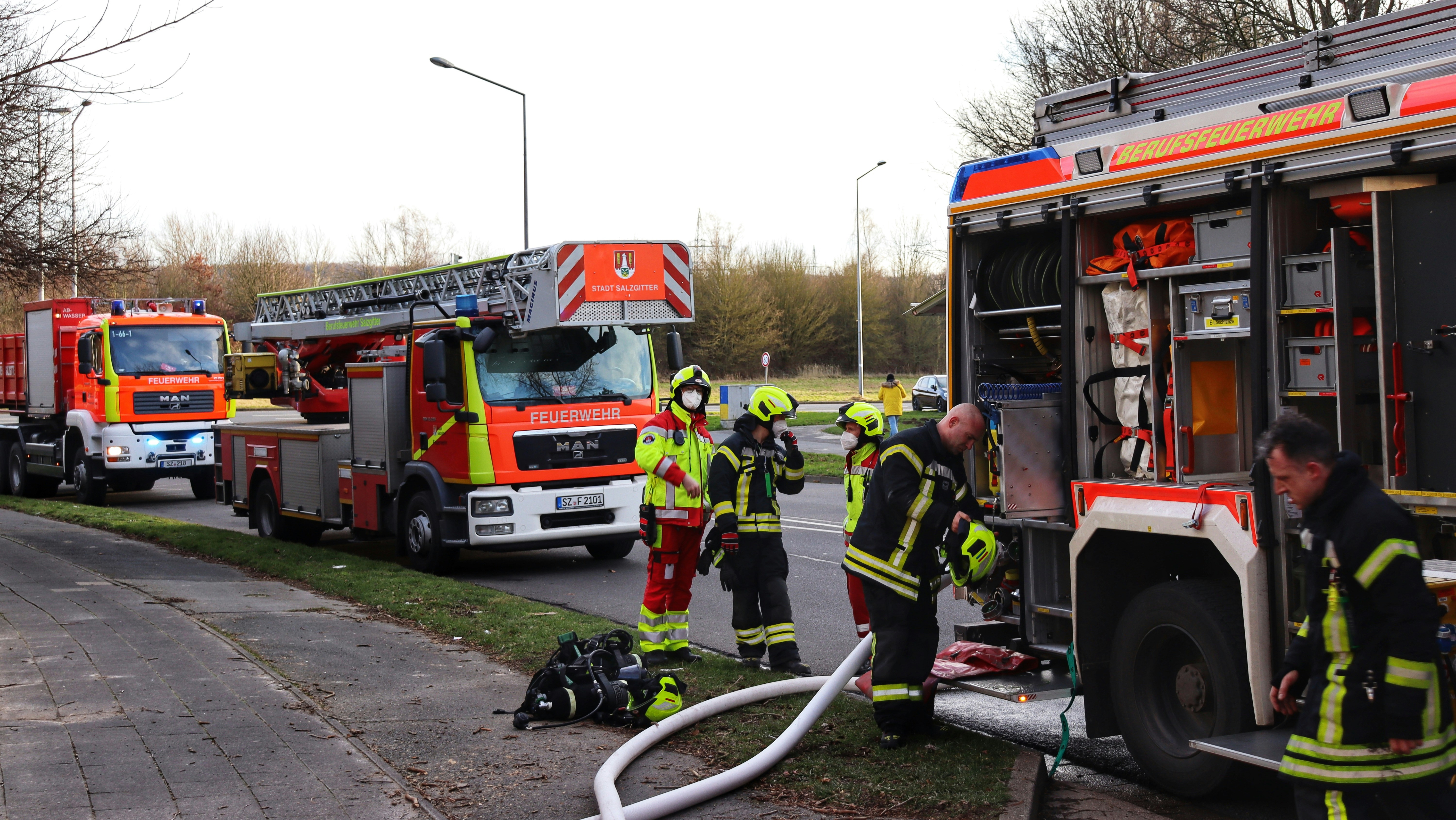 a group of firemen standing next to a fire truck