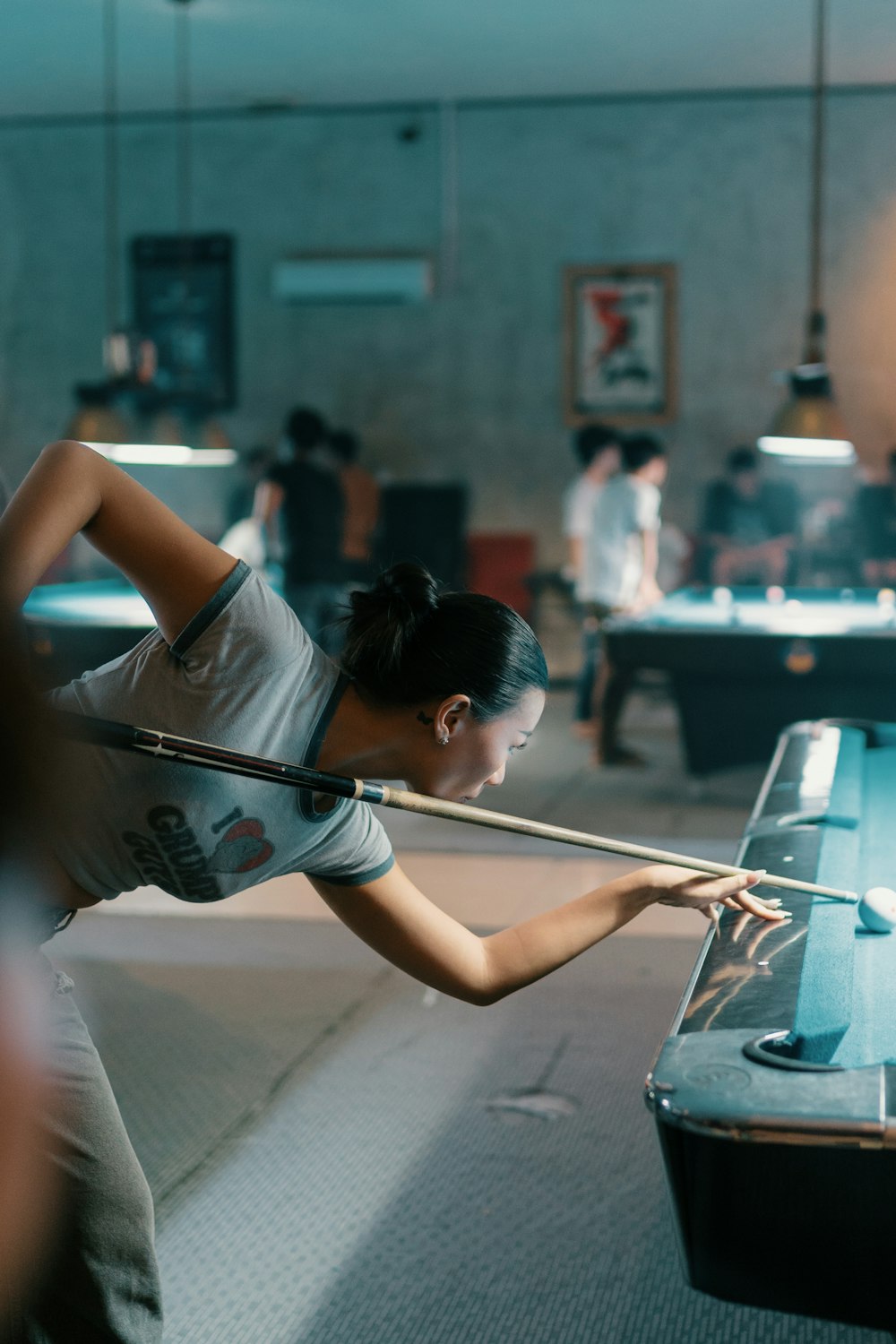 a woman is playing a game of pool