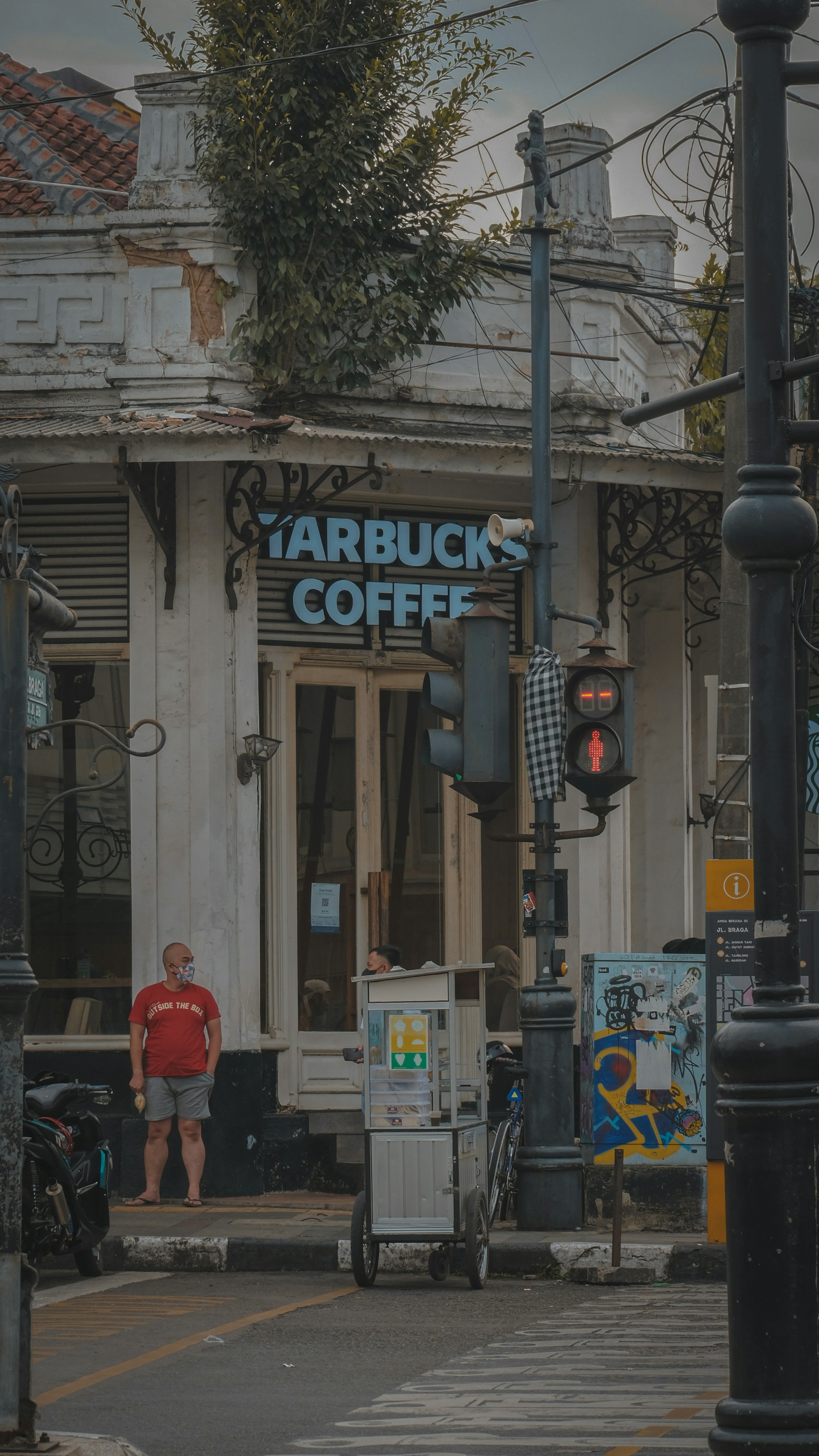 a man standing in front of a coffee shop