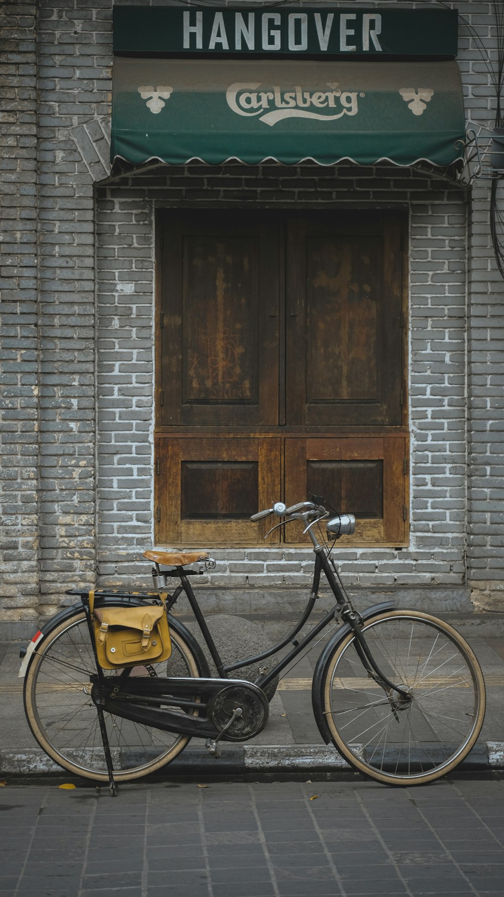 a bicycle parked in front of a brick building