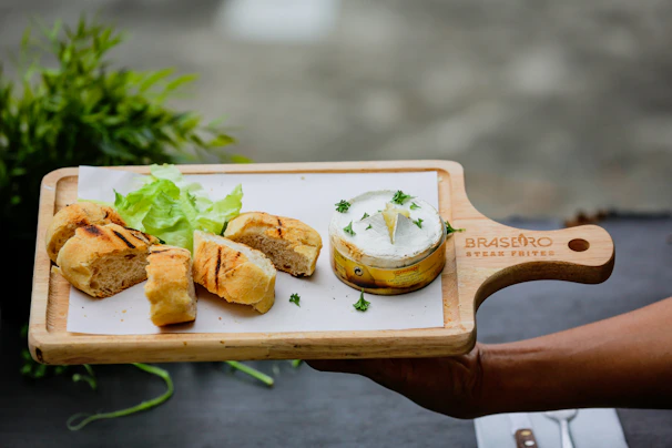 Freshly made arepas stuffed with shredded beef and avocado, served on a rustic wooden board.