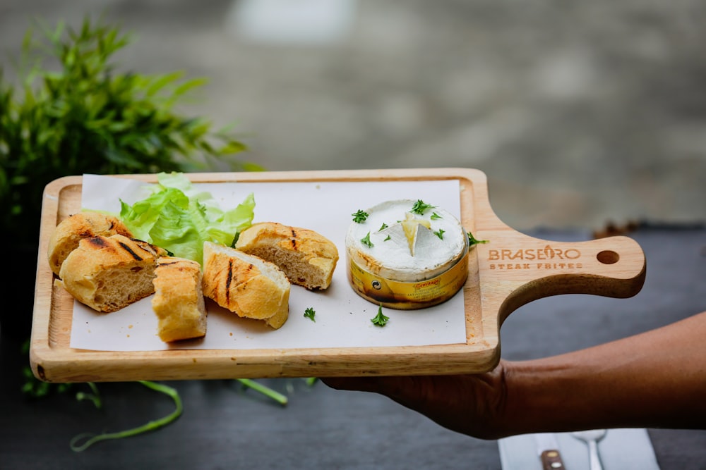 a person holding a tray with food on it