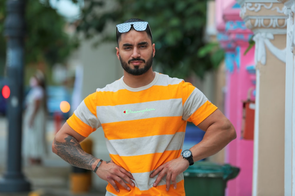 a man wearing a striped shirt and sunglasses