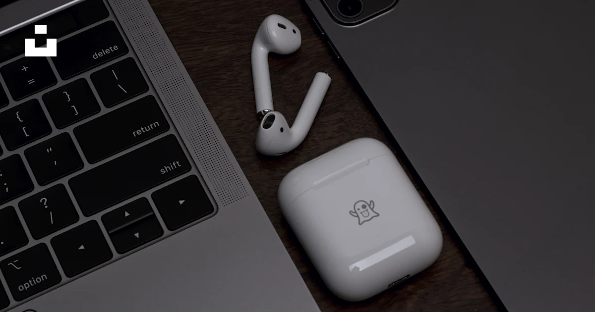 Computer Ear Plug A pair of ear buds sitting next to a laptop photo – Free Product Image ...