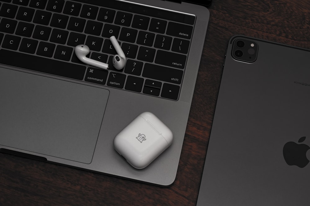 an apple laptop computer sitting next to an apple mouse