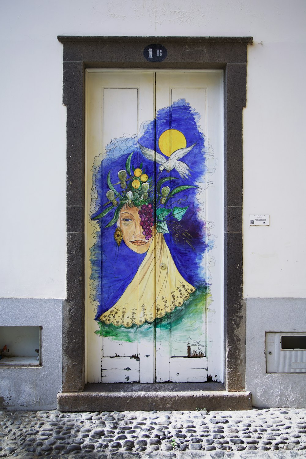 a door with a painting of a woman holding a bouquet of flowers