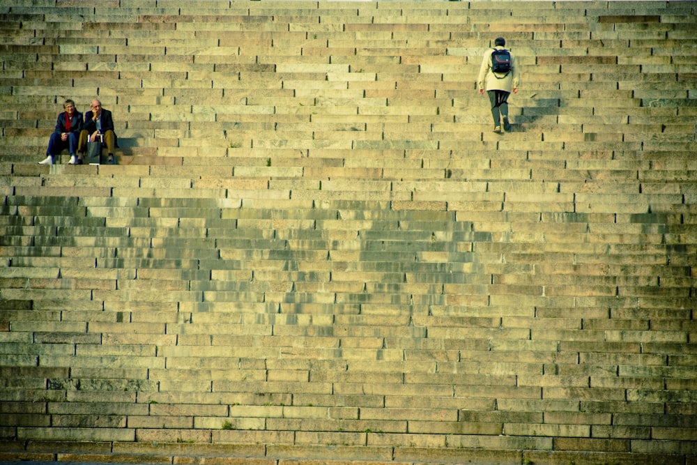 a group of people standing on top of a brick wall