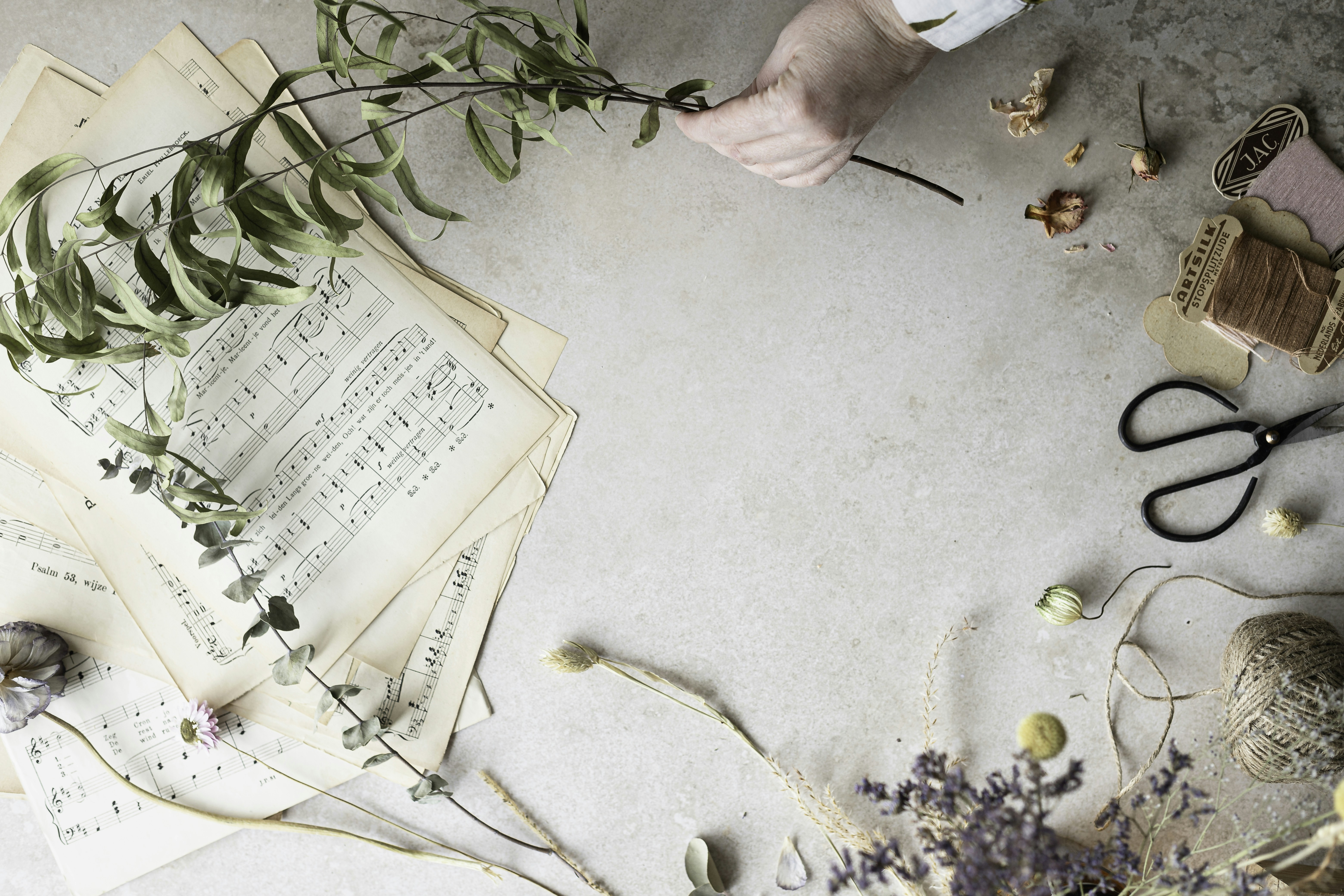 a table topped with lots of papers and flowers