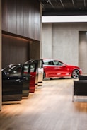 a red car is parked in a building