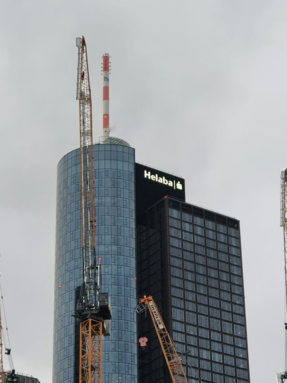 a tall building with a crane in front of it