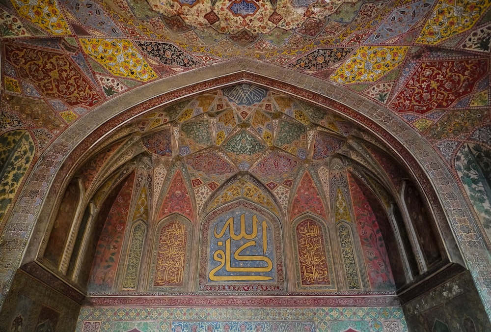 an ornate building with a gold and blue sign on the wall