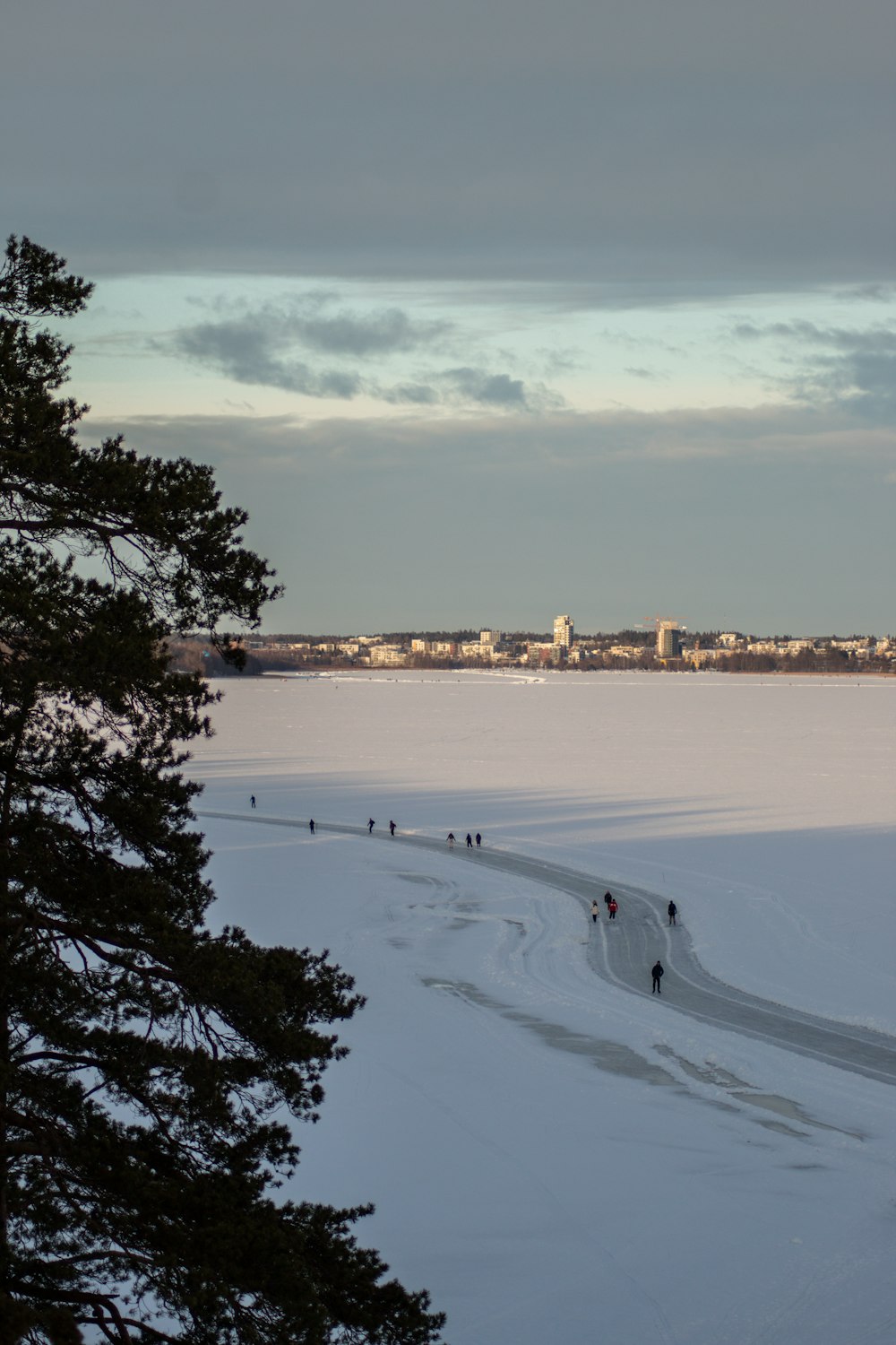 a group of people walking across a snow covered field