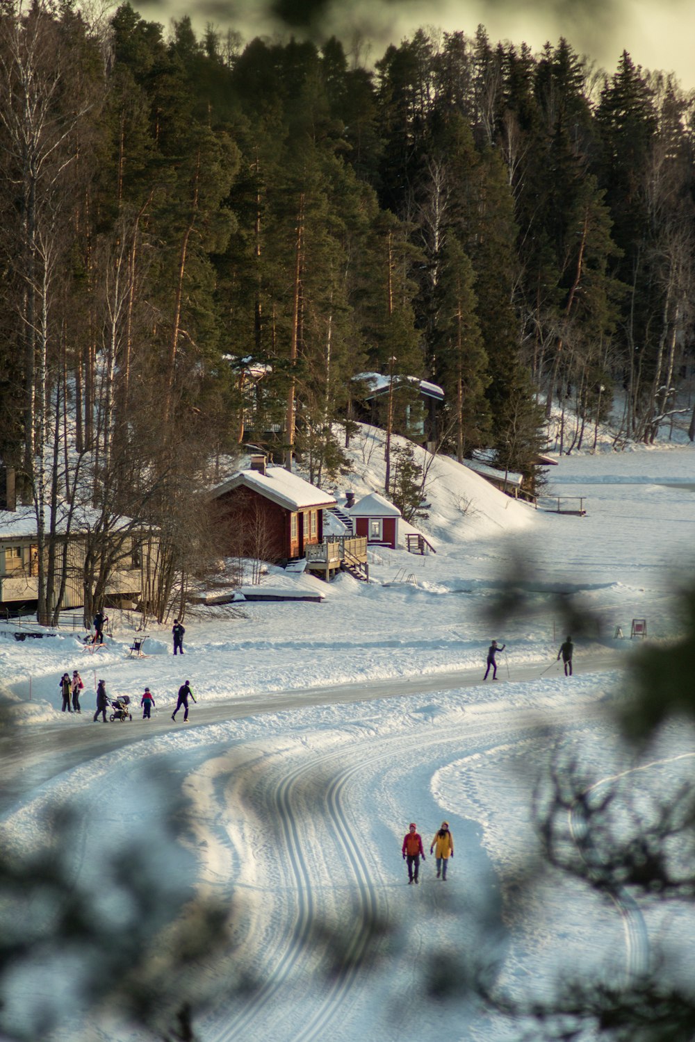 a group of people riding skis down a snow covered slope