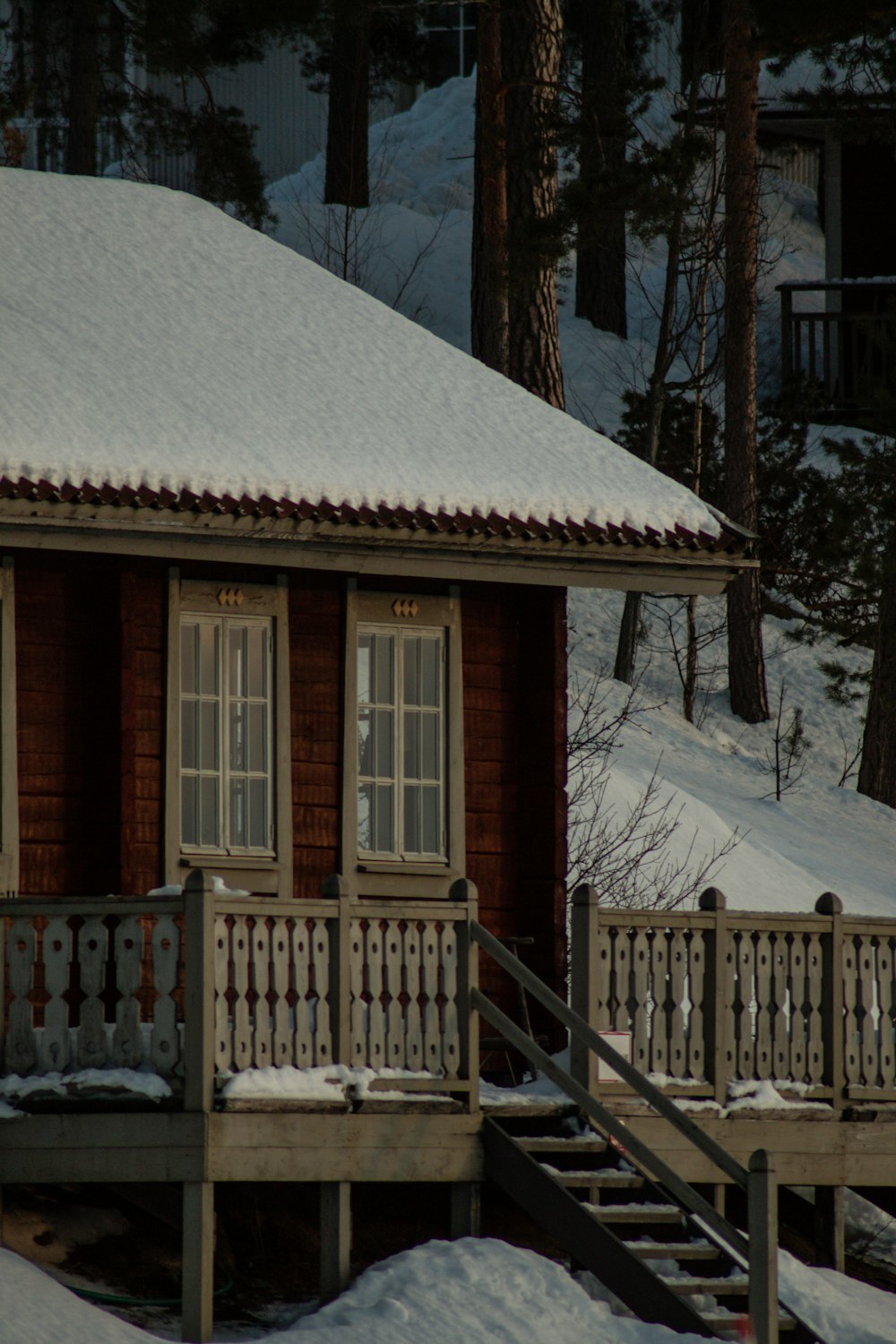 a small cabin with a snow covered roof