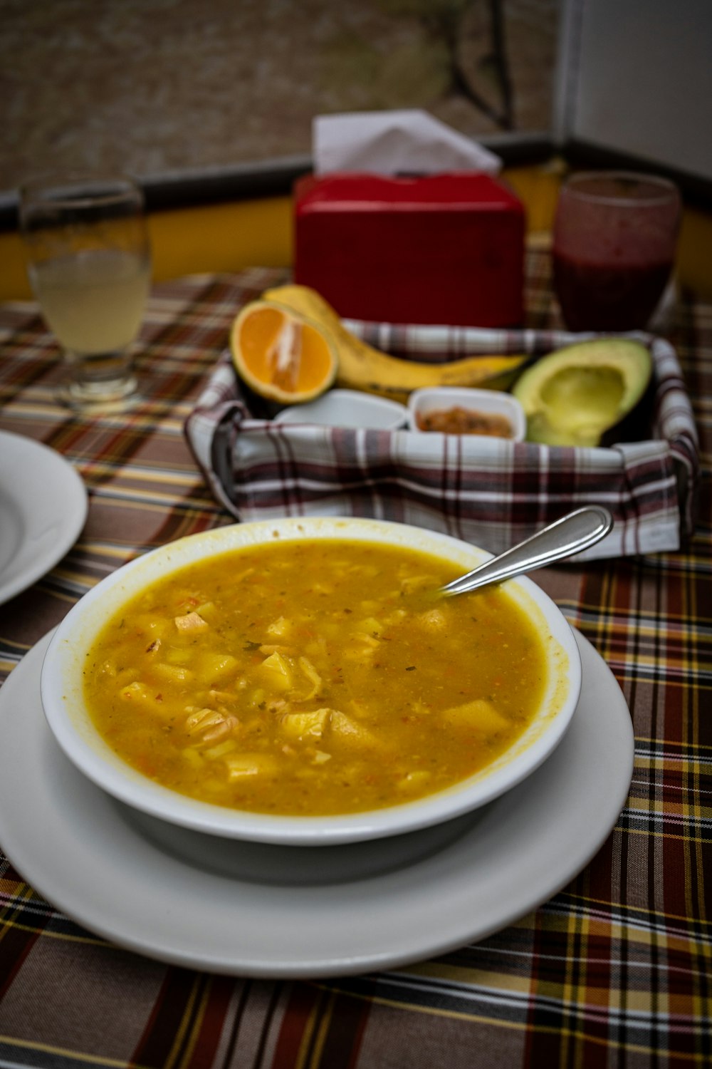 a bowl of soup with a spoon on a table