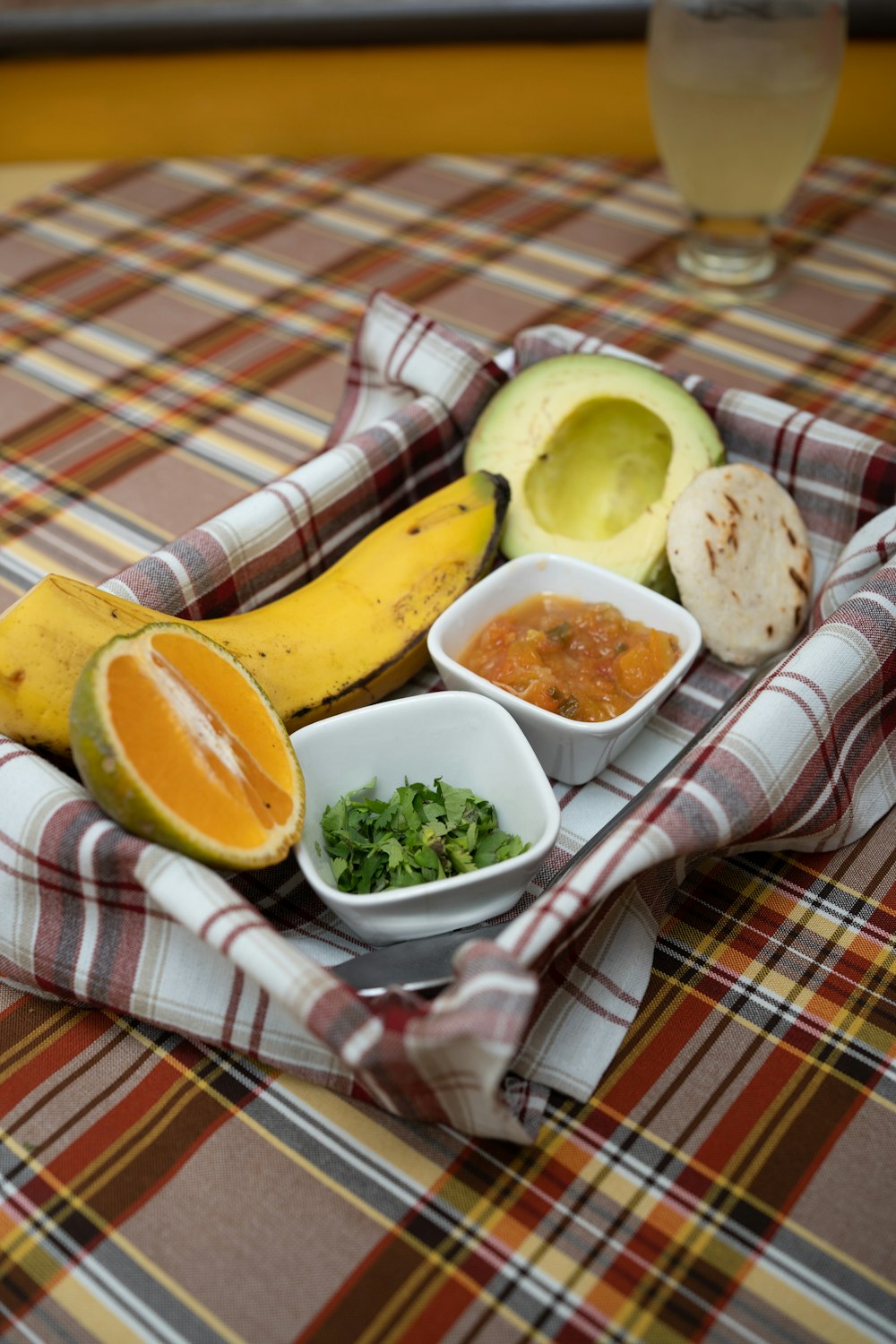 a table topped with bowls of food and a banana