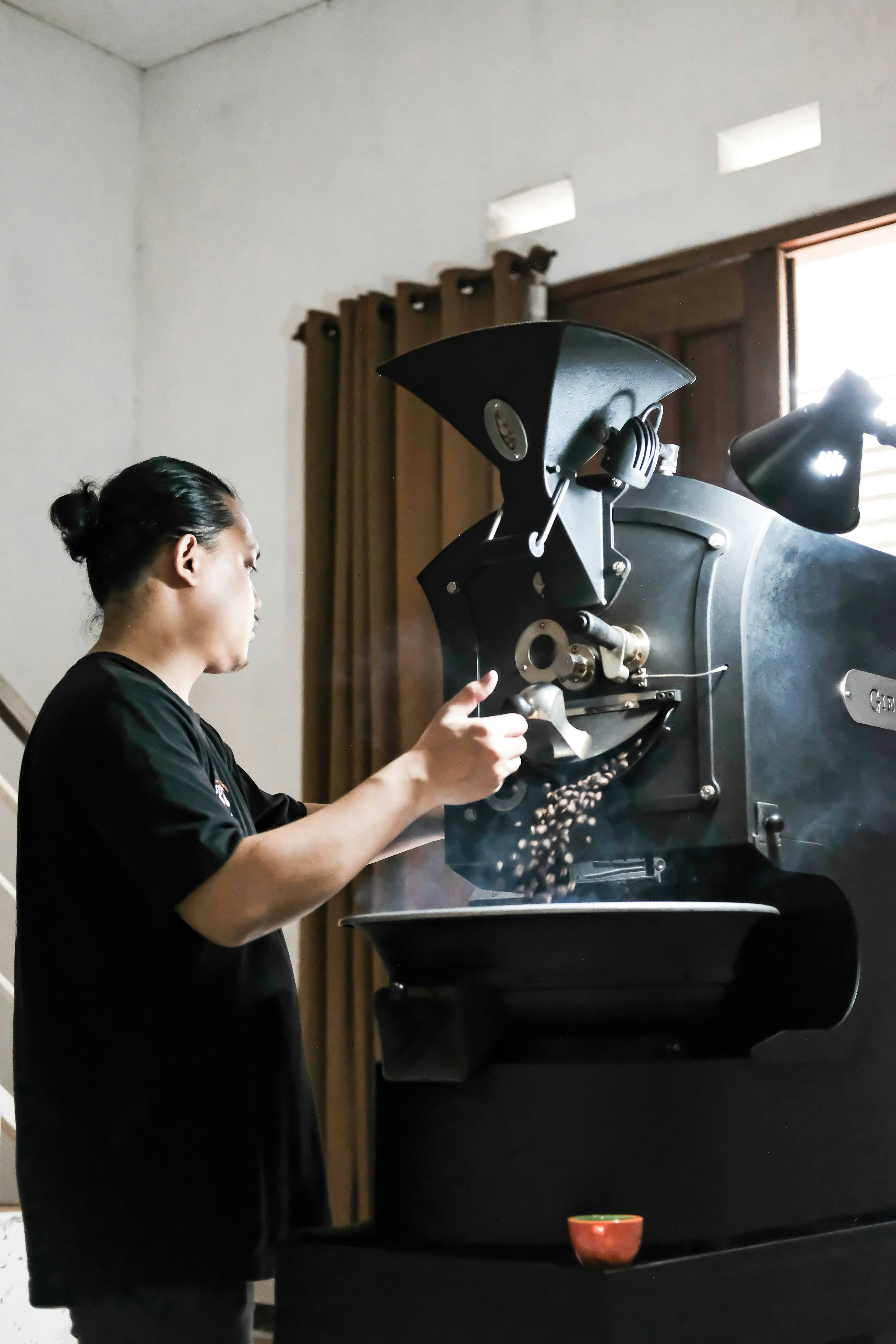 a woman is working on a coffee machine