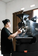Artisan roasting machine glowing warmly as beans tumble inside.