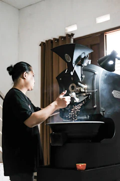 Artisan roasting machine glowing warmly as beans tumble inside.