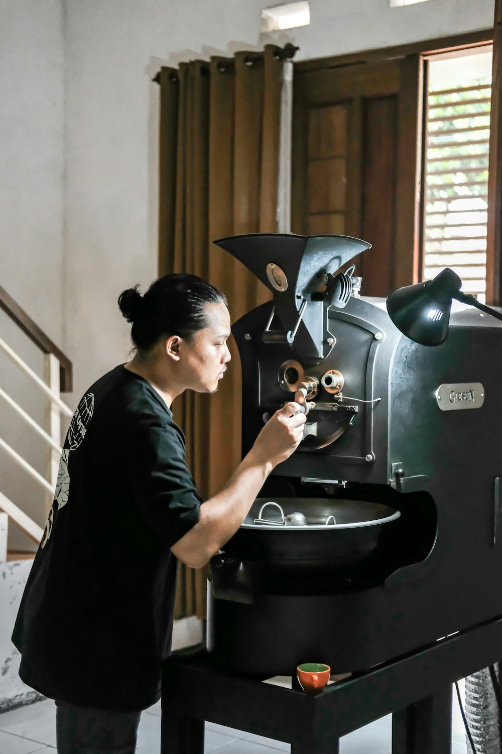 a woman is working on a coffee machine