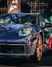a blue sports car parked on the side of the road