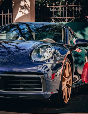 a blue sports car parked on the side of the road