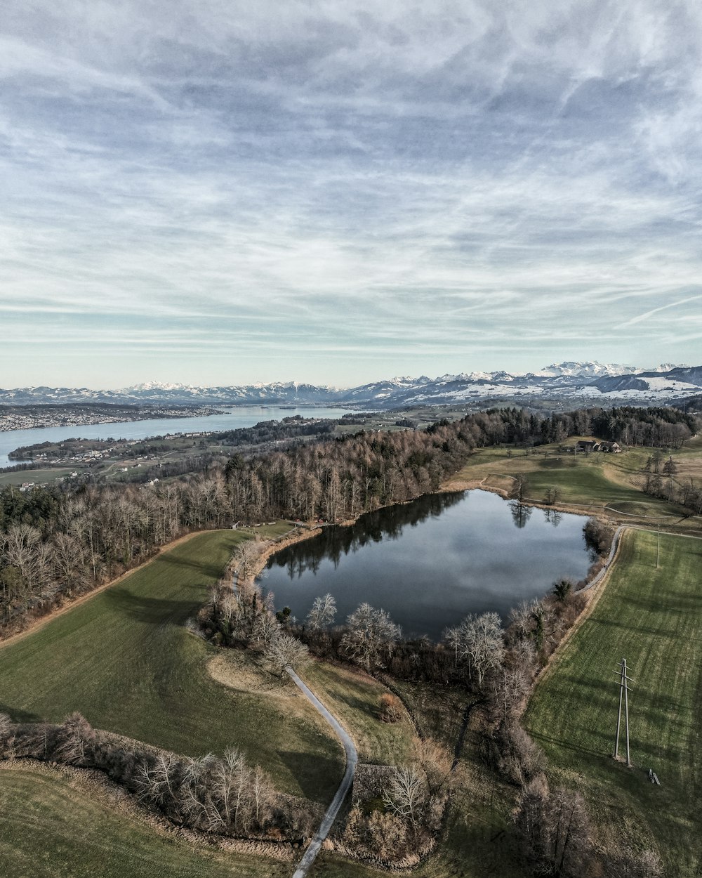 an aerial view of a lake surrounded by trees