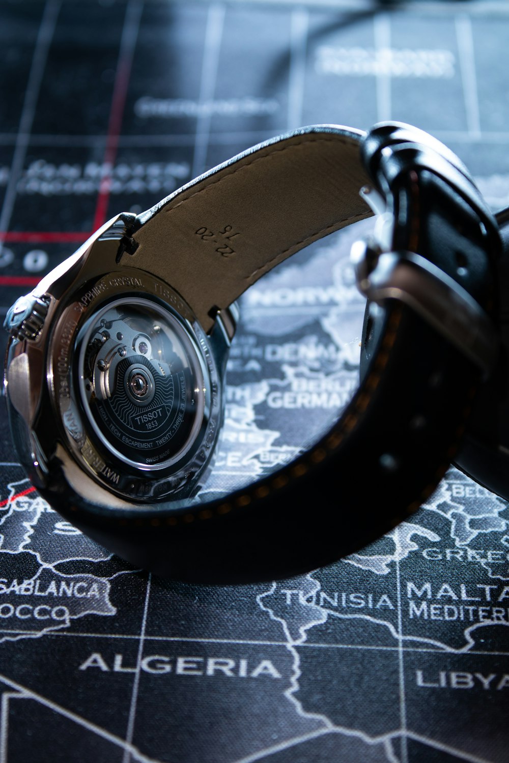 a close up of a watch on a map
