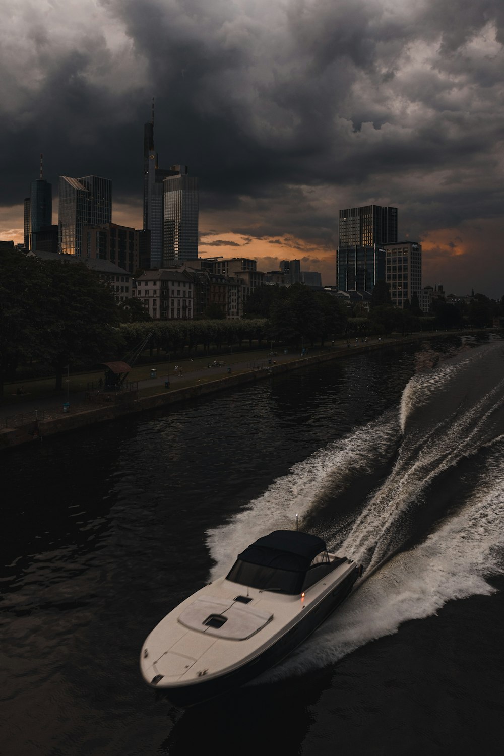 a speed boat speeds through the water in front of a city skyline