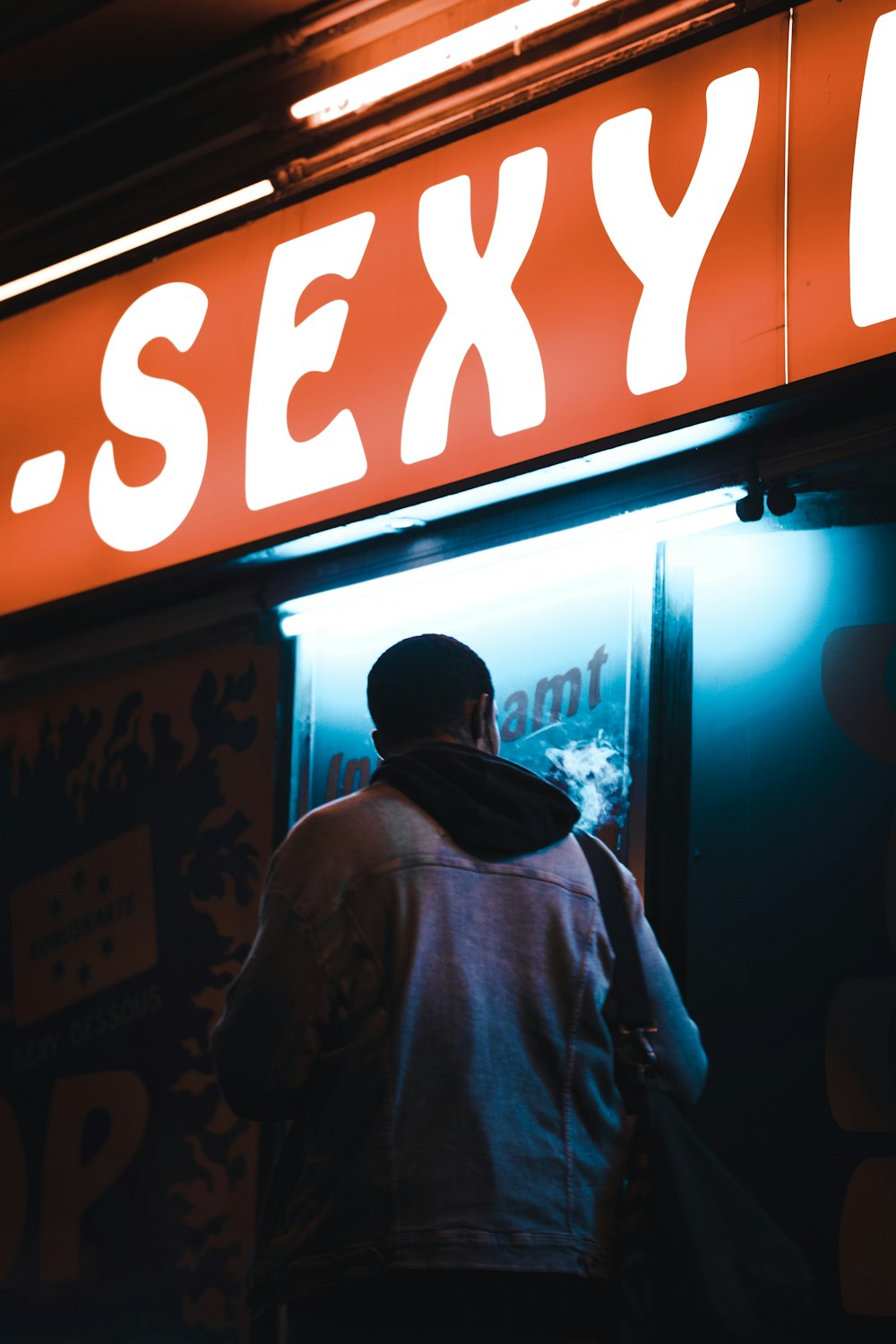 a man standing in front of a sexy bar