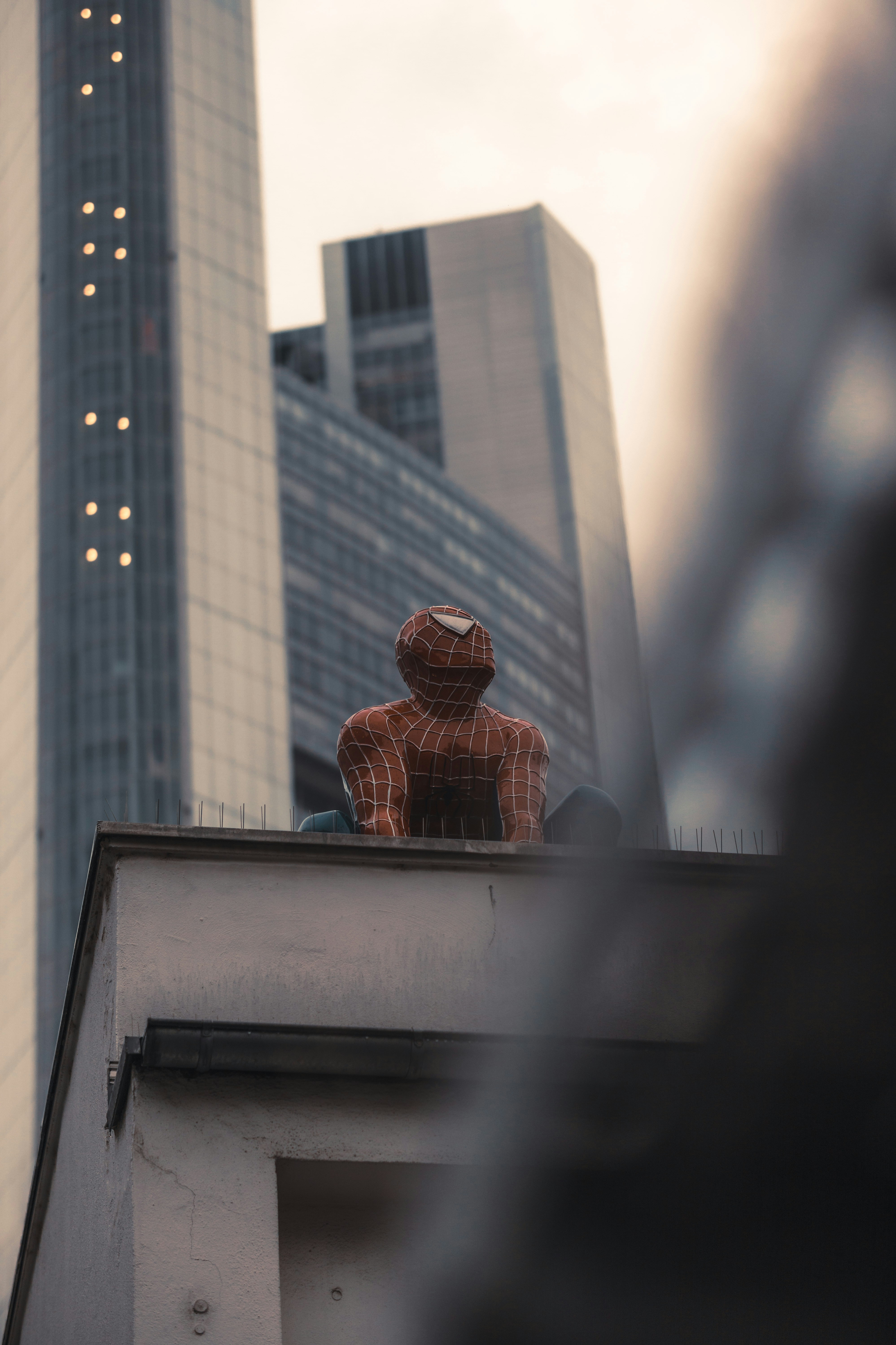 Spider-Man swinging between buildings