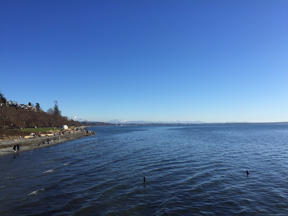 a body of water with people walking on it