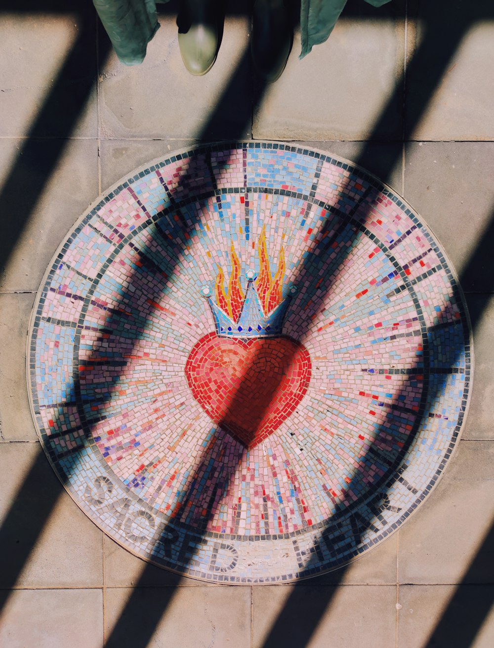 a mosaic table with a heart and a crown on it