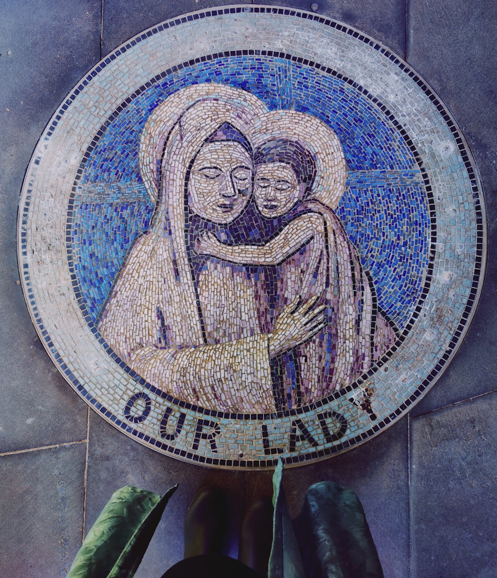 a mosaic of two women hugging each other