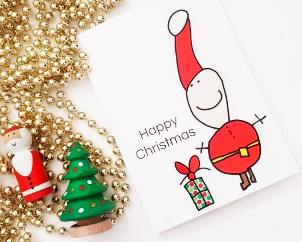 a christmas card next to a christmas tree