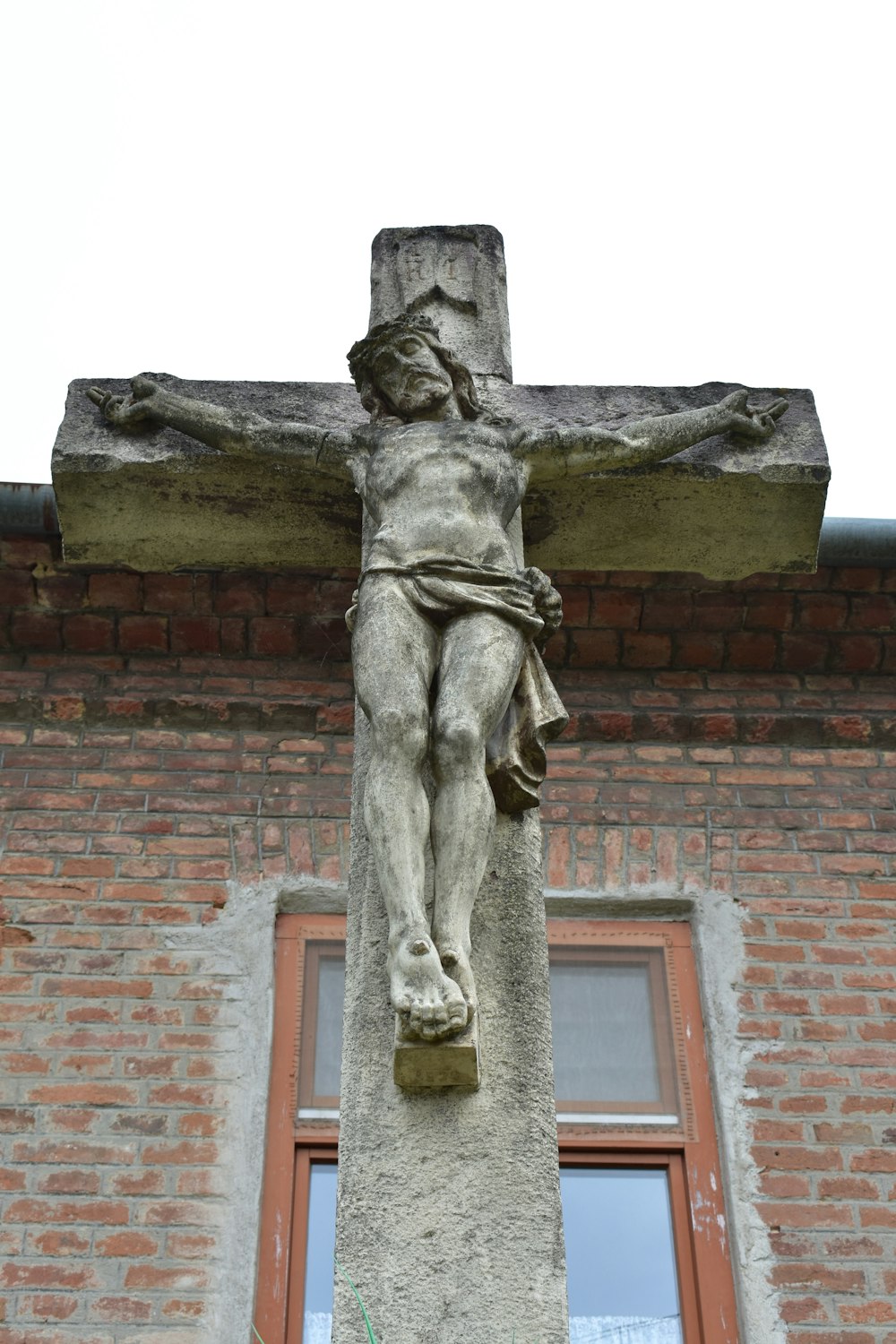 a statue of jesus on a cross on a building